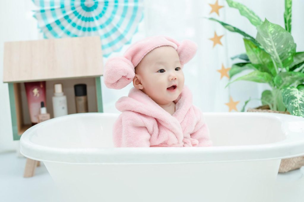 bath time for a baby girl wearing pink 